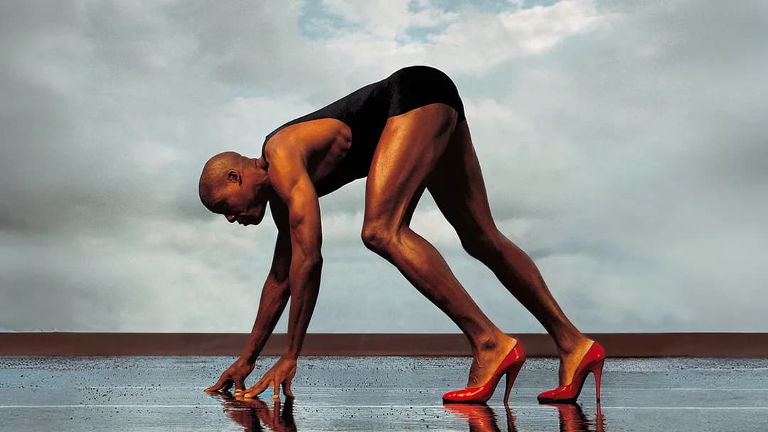 Carl Lewis profile in sprint start stance, in red heels.