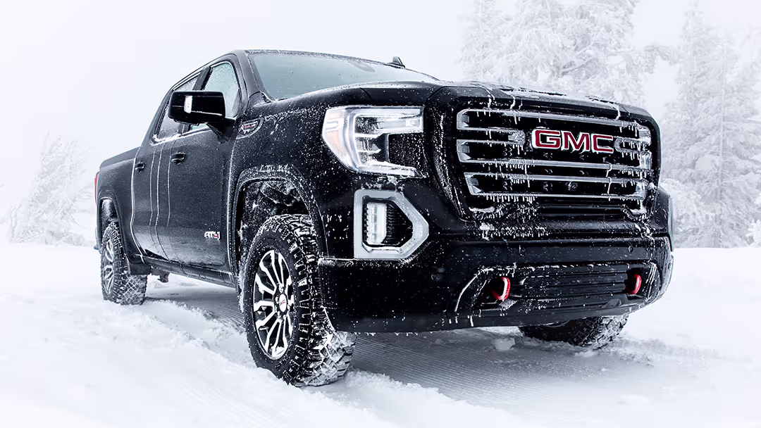 Black GMC Sierra in a snow environment with ice on the grille.